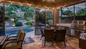 A covered patio with a pool, outdoor seating, and a barbecue area. - Scottsdale Grayhawk entire house with Private Pool, Sunroom, Office (Scottsdale)
