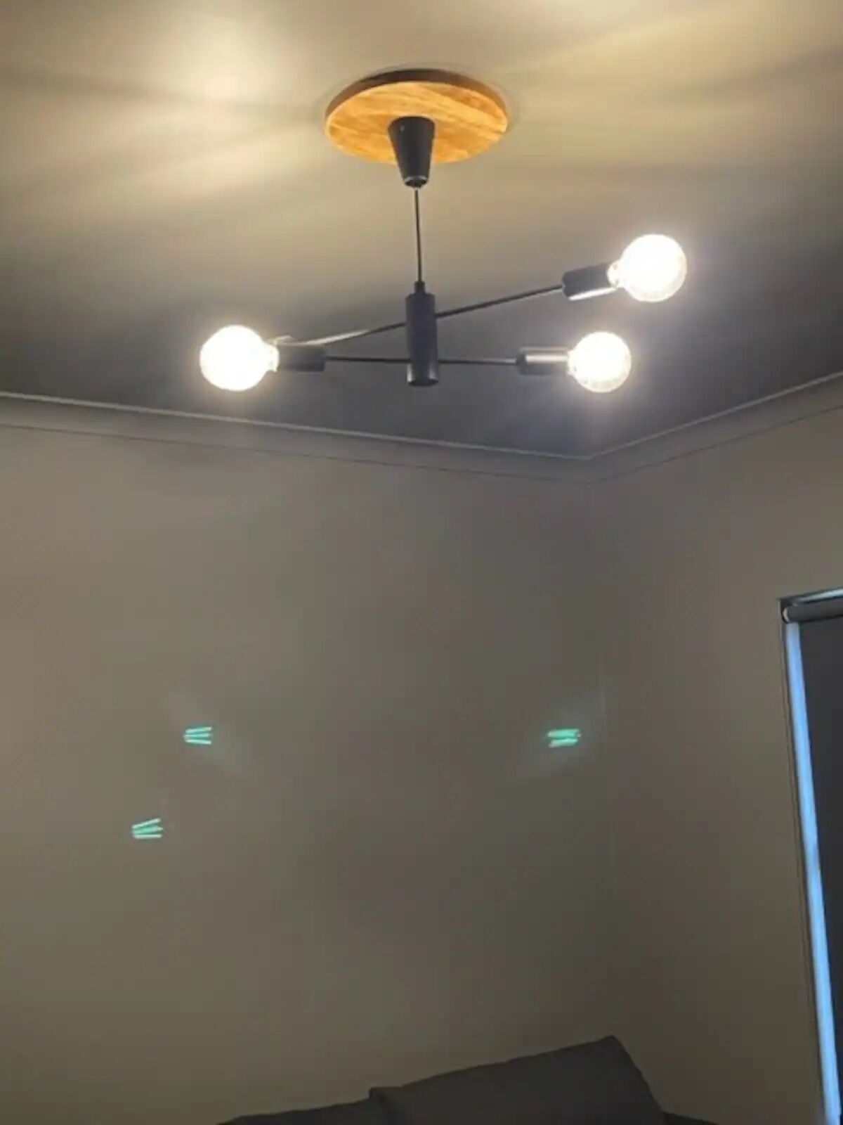 A ceiling with a central light fixture and three smaller lights on either side.