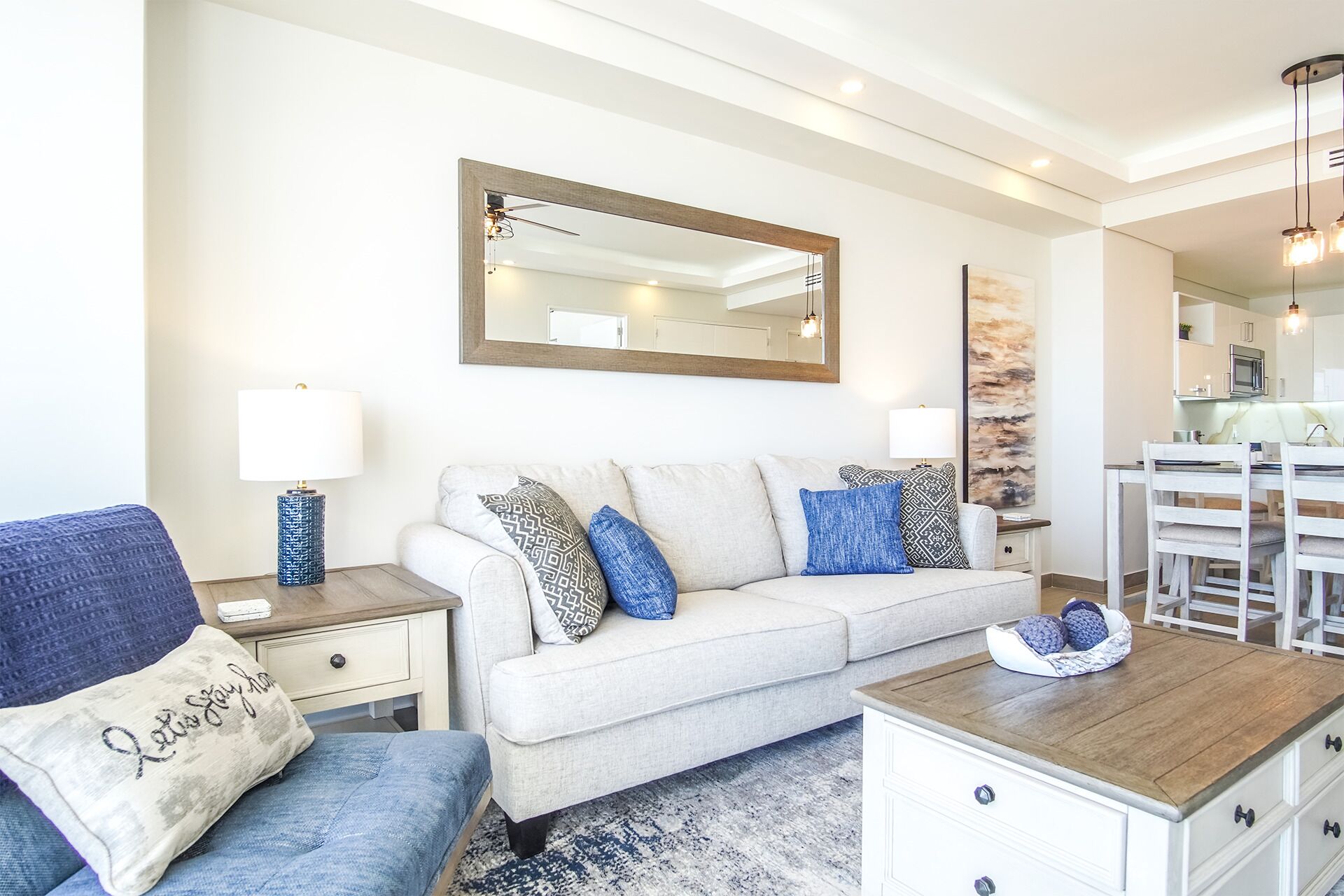 A modern living room with a sofa, a coffee table, and a dining area.