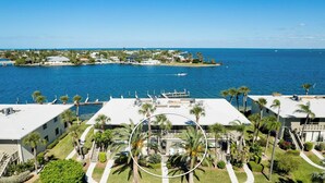 A coastal property with a marina, palm trees, and a view of the ocean.