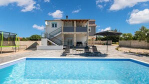 A two-story house with a swimming pool in front. - Pet friendly home in Tinj (Tinj)