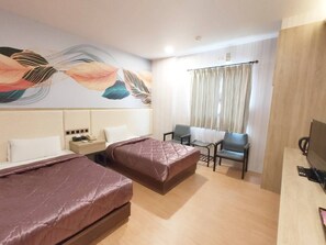 A hotel room with two beds, a small table, a chair, a TV, and a decorative wall mural. - ROYAL BUSINESS HOTEL (Nantou)