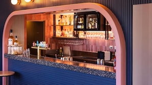 A bar area with a counter, shelves of bottles, and glasses. - Torquay Hotel Motel (Torquay)