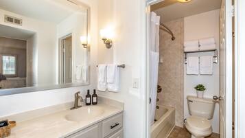 A bathroom with a sink, mirror, towel rack, and toilet.