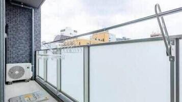 Apartamento família, 2 quartos, para não fumantes, vista para a cidade | Sacada