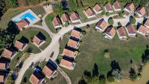 Un barrio residencial con casas dispuestas en semicírculo alrededor de una piscina central.