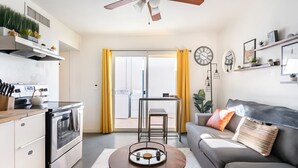 A modern apartment with a kitchen, dining area, and living room. - Bright 4BR Getaway – Yard & Perfect Group Escape! (Tucson)