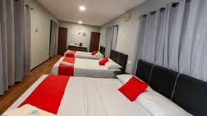 A hotel room with three beds, each with a red and white bedspread, and grey curtains. - Grapevine Garden (Kota Kinabalu)