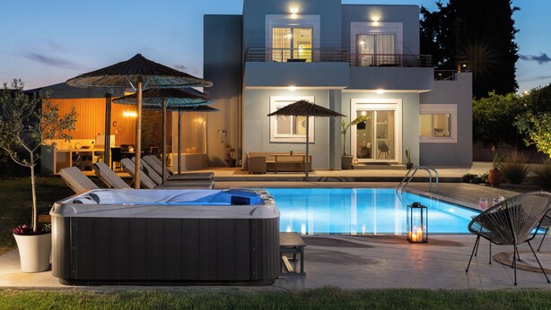A modern two-story house with a swimming pool, hot tub, and outdoor seating area. - Ethria Pool Villa with heated jacuzzi (Αφάντου)
