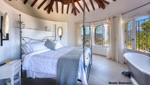 A master bedroom with a large bed, a bathtub, and a view of the outdoors. - Fabulous 5 Bedroom Villa near Cannes perfect for the Lions Festival. 
 (Théoule-sur-Mer)