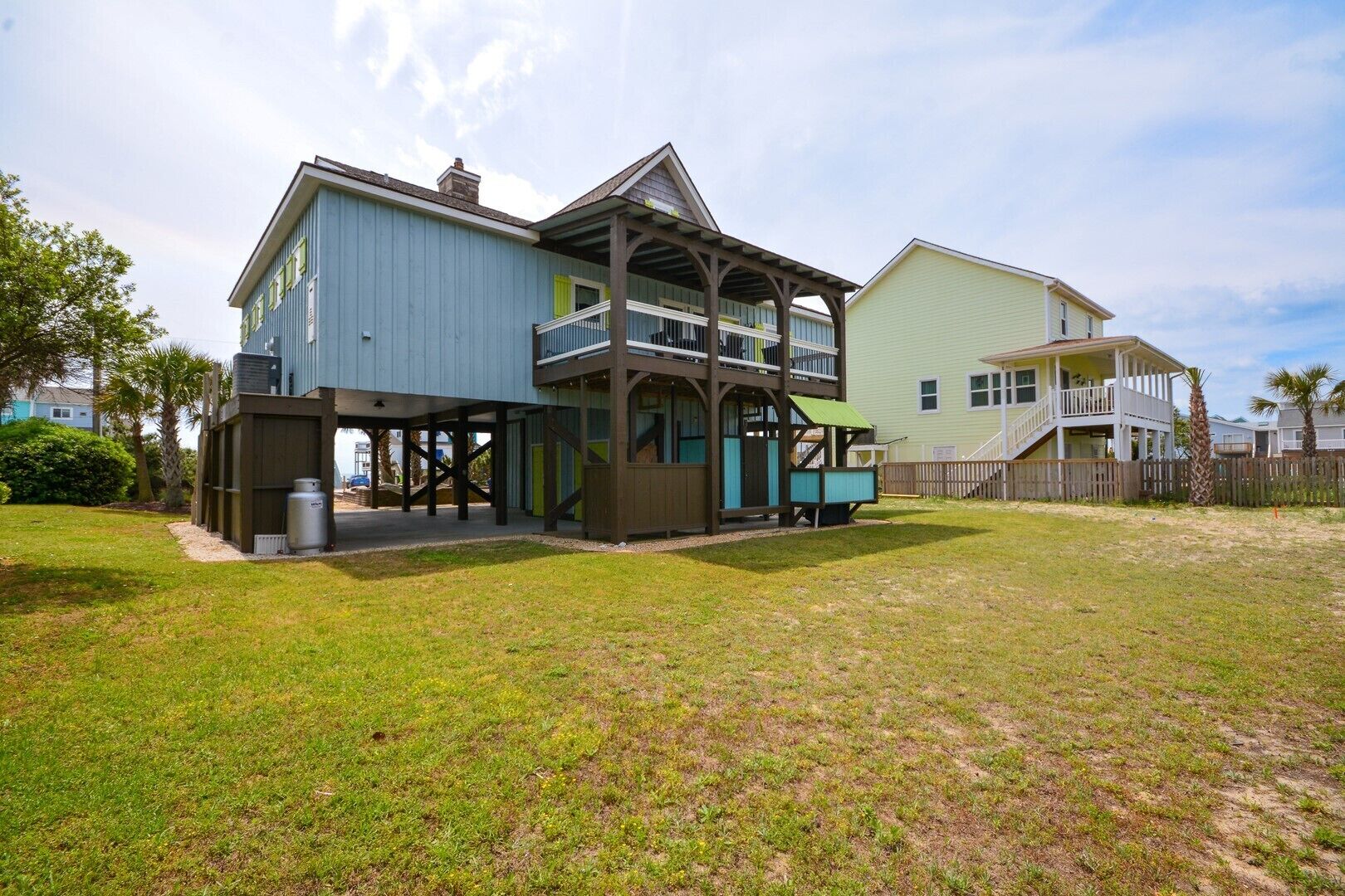 A two-story house with a covered patio and a separate garage.