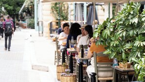 A street-side café with outdoor seating, tables, and potted plants. - Play Psyri, a member of Brown Hotels (Athens)