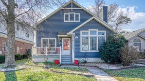 A two-story house with a front porch, a chimney, and a mailbox. - Family Tides-311 139th St-Bayside W/D, AC, WIFI (Ocean City)