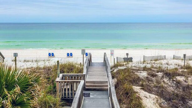 A wooden boardwalk leading to a beach with clear turquoise water and a sandy shore. - Palms 204 Beachfront Condo with Free Beach Service! (Fort Walton Beach)