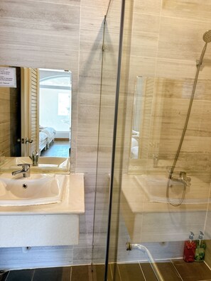 Family Triple Room, Multiple Beds | Bathroom | Separate bathtub and shower, rainfall showerhead, designer toiletries