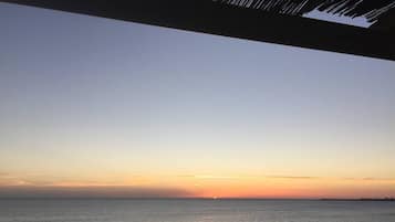 A coastal view with a clear sky, a calm sea, and a distant horizon.