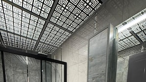 Un baño moderno con inodoro, lavabo y zona de ducha.
