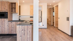 Een moderne keuken met houten kastjes en een inbouwoven.