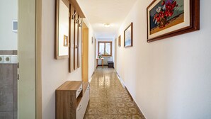 A hallway with a wooden cabinet, a radiator, and a framed painting on the wall. - Farmhouse 'Bauernhof Oberkapillhof 2' with Mountain View, Shared Garden and Wi-Fi (Meltina)