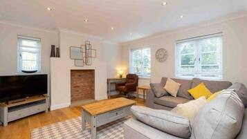 Deluxe Townhome | Living area | 47-inch Smart TV with digital channels, TV, Netflix