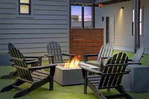 Relax in the outdoor seating area with Adirondack chairs and a fire pit.