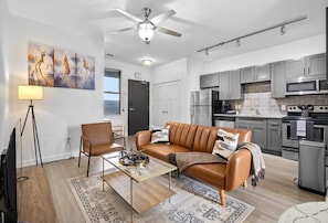 Relax in this stylish living space with a comfortable sofa, armchair, and flat-screen TV.