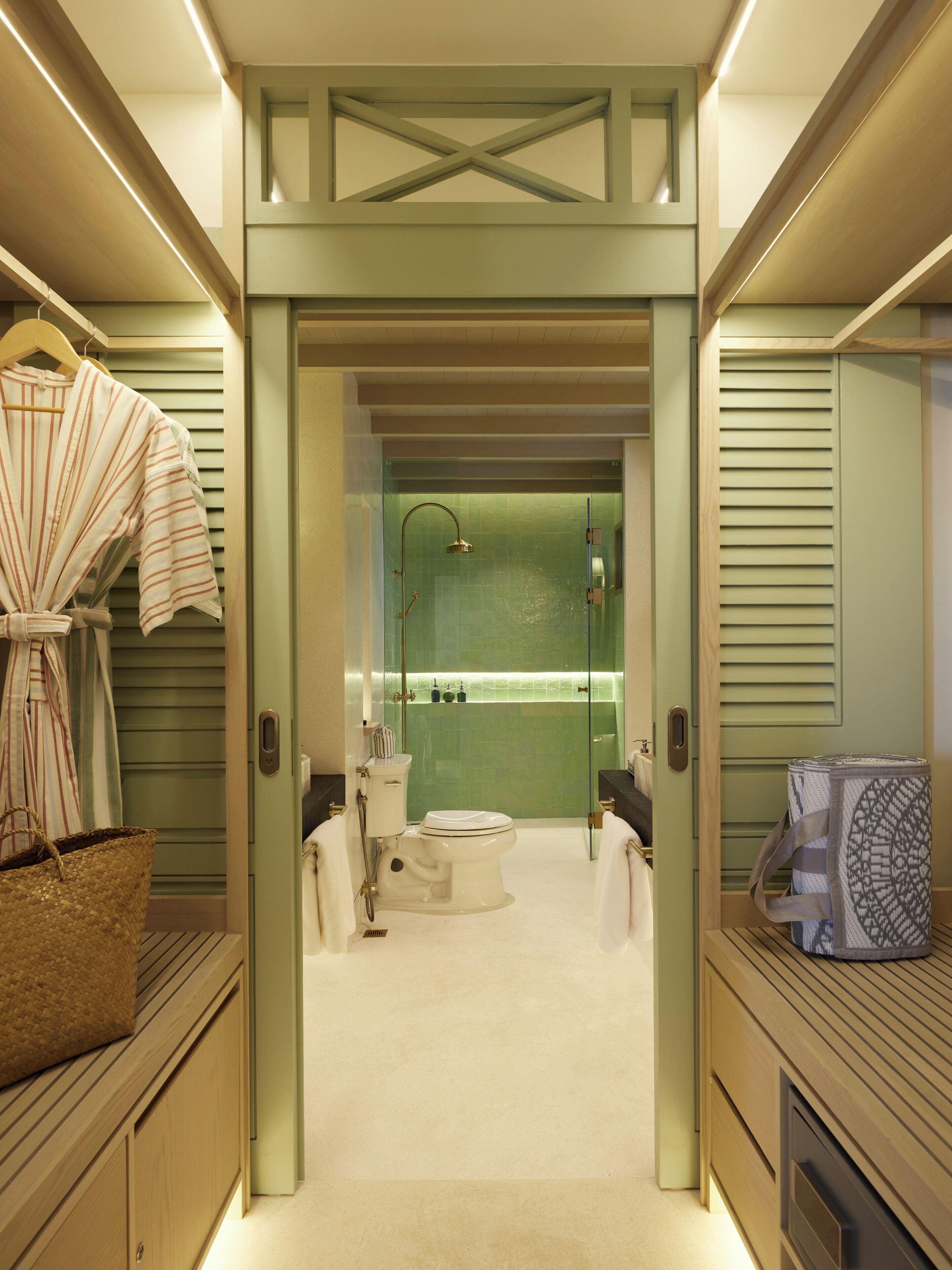 A modern bathroom with a shower, toilet, and sink.