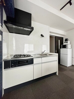 Fridge, microwave, stovetop, cookware/dishes/utensils - Nagomi by b hotel | 2 Bedrooms & Dining (Naka Ward, Hiroshima)