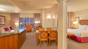 A hotel room with a kitchenette, a dining area, a bed, and a bathroom. - 2 BR/2 BA with Kitchen at Hilton HGVC (Las Vegas)