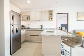Eine moderne Küche mit Einbaukühlschrank, Mikrowelle und Kaffeemaschine.