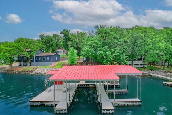 Enjoy serene lakeside views from the dock, offering easy access to the water and comfortable seating areas.