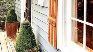 A house with a porch, wooden shutters, and a window with a view of the interior. - Lake, Golf & Hike at Linville Lodge in  Linville  Land  Harbor  Resort Community (Newland)