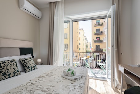 Deluxe Room, 1 Queen Bed, Balcony, City View | 1 bedroom, individually decorated, individually furnished, desk