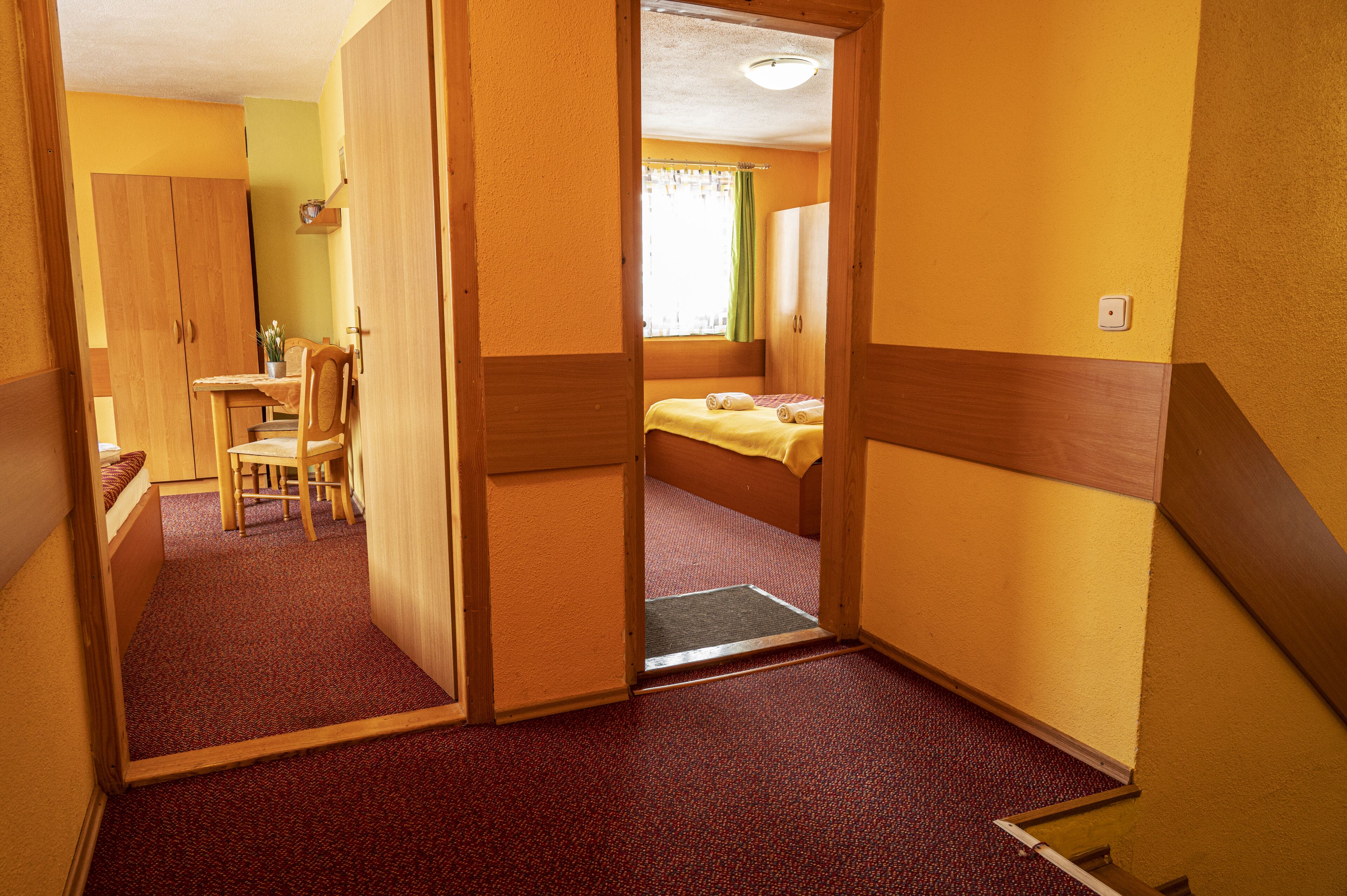 A room with a bed, a desk, and a chair.
