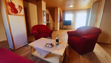 Deluxe Apartment, 2 Bedrooms | Living area | TV, toys, heated floors