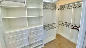 A walk-in closet with open shelves, hanging space, and drawers. - Penthouse with Unobstructed Views! (San Pedro)