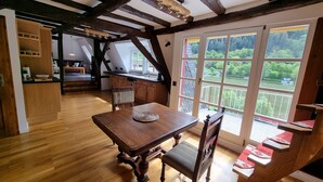 A spacious kitchen with wooden cabinets and a large window overlooking a scenic landscape.