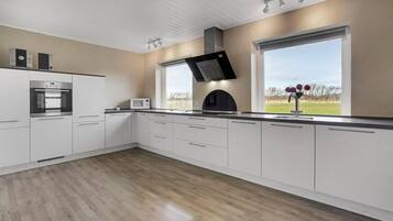 Fridge, stovetop, dishwasher, coffee/tea maker