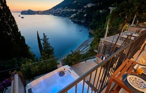 A balcony with a hot tub overlooking a coastal town at sunset. - Cozy apartment in Dubrovnik with WiFi (Dubrovnik)