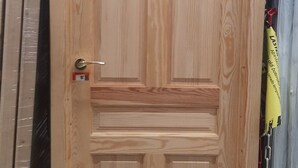 A wooden door with a price tag of 145 euros, indicating it is for sale.