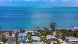 A coastal residential area with houses, a clear view of the ocean, and a bridge in the distance. - Bay 2 Bay: Bay Across Street! Amazing Views of Bay & Canal, Pool & Lounge by Anna Maria Life (Anna Maria)