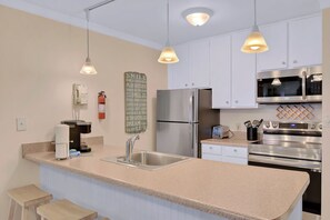 Enjoy cooking in this well-equipped kitchen with a refrigerator, microwave, double oven, and coffee maker.