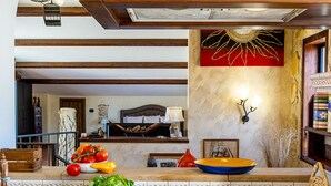 A kitchen with a gas stove, a sink, and a countertop with a bowl and vegetables. - Villa TreA - Loft Alba (Mascali)