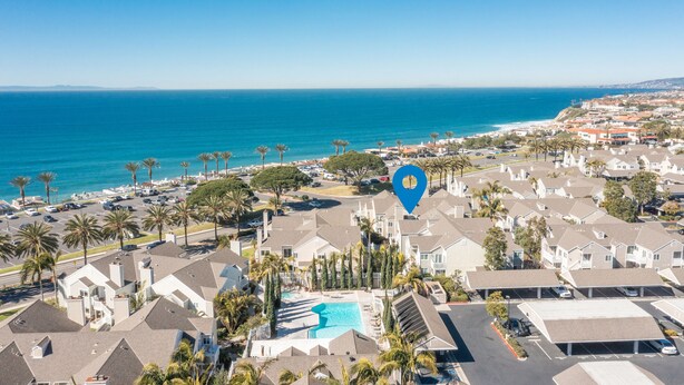 A residential area with a swimming pool, houses, and a view of the ocean. - LOWER Unit at Niguel Beach Terrace, Dana Point!  Close to Pool  view (Dana Point)