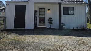 A small, single-story building with a white exterior and a metal roof.