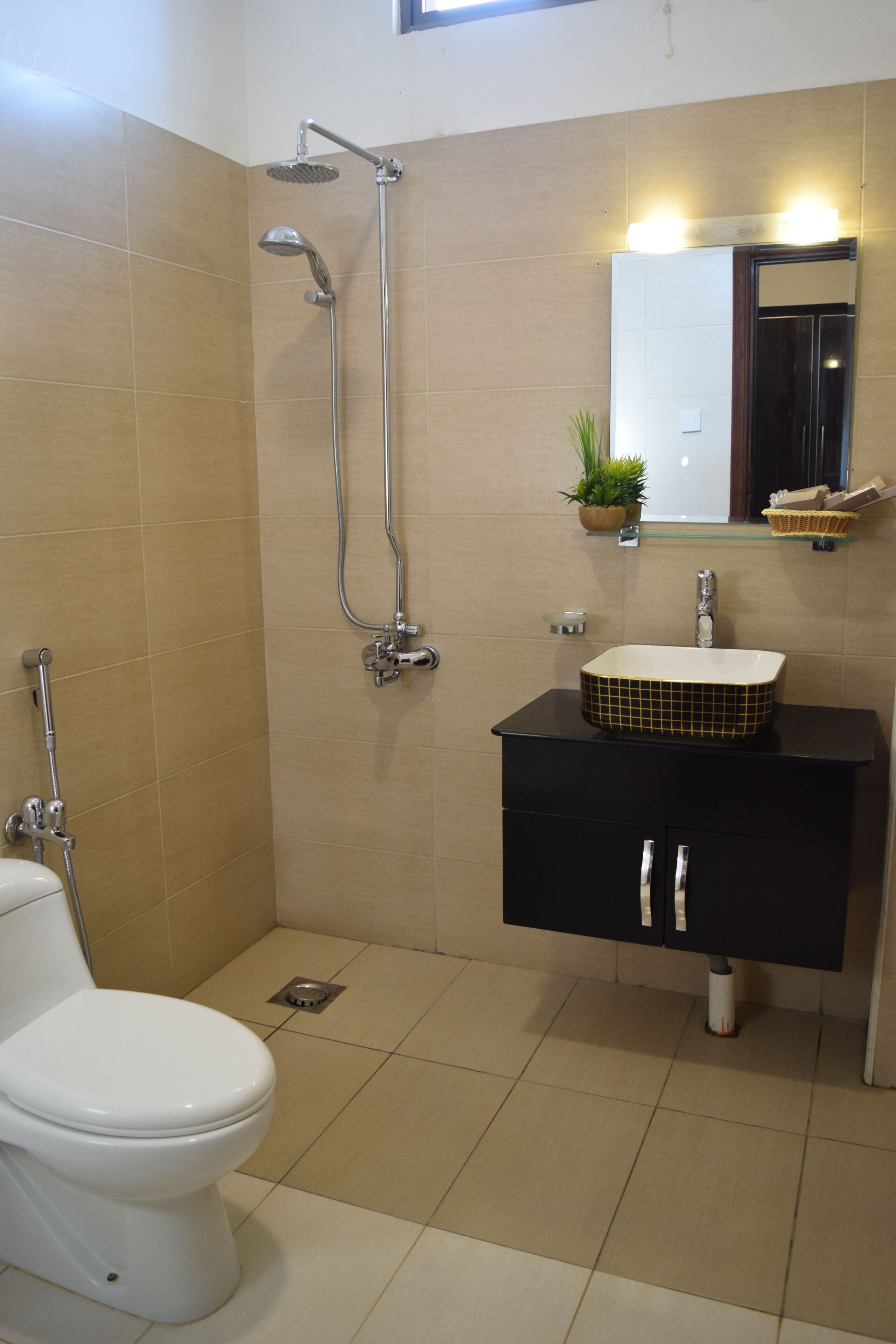A bathroom with a toilet, sink, and shower.