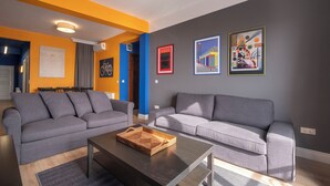 A modern living room with two grey sofas, a coffee table, and artwork on the walls. - Hip 2BR Apartment · Bosphorus & Dolmabahçe View · Central Beyoğlu (Beyoğlu, İstanbul)