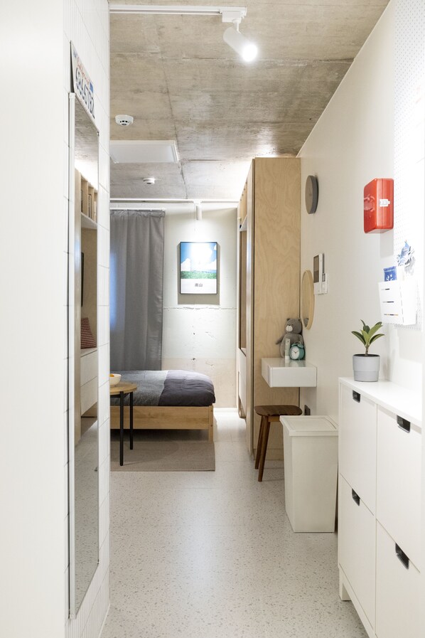 A compact, modern room with a bed, a small desk, a sink, and a potted plant. - Designers ON:the zip in Mangwon #1 (Pocket-fi) (서울특별시)