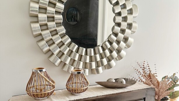 A dark wooden console table with three decorative vases and a large, circular mirror with a metallic frame. - Beautiful modern family home ,centrally located ,close to everything (Bli Bli)