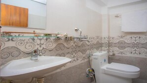 A bathroom with a sink, toilet, and shower.